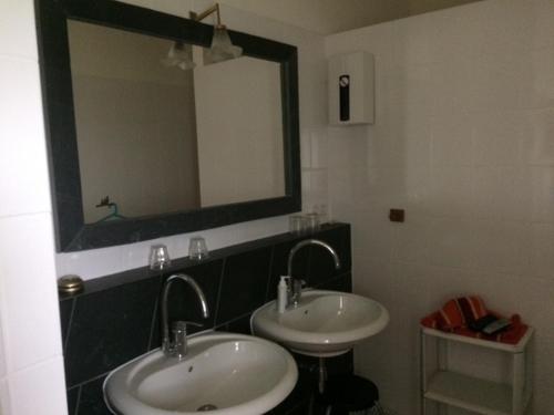 a bathroom with two sinks and a large mirror at Knochenhaus in Schmallenberg