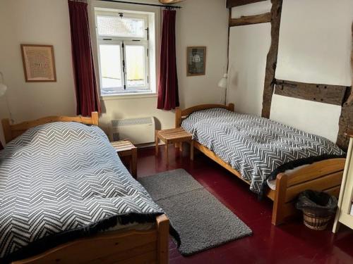 a bedroom with two beds and a window at Knochenhaus in Schmallenberg