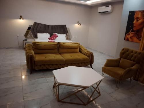 a living room with a couch and a table at Mar'maris Residence Hotel in Owerri