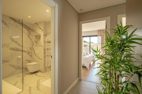 a glass door leading into a bathroom with plants at CADIAMARE in Zonza