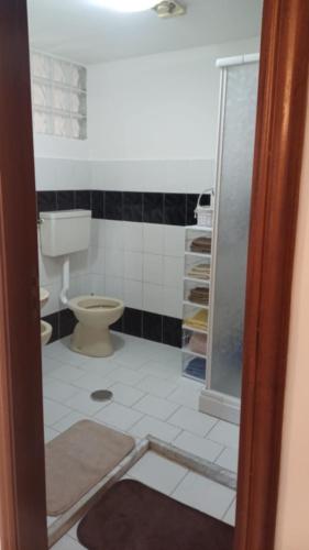 a bathroom with a toilet and a glass shower at Casa vacanze Sisters in Vatolla