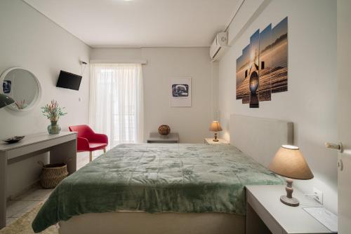 a bedroom with a large bed and a red chair at Lida Apartments in Kalamata