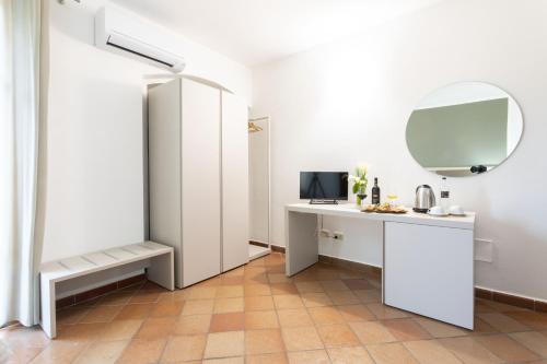 a white room with a desk and a mirror at Podere San Michele Cantina con Camere in San Vincenzo
