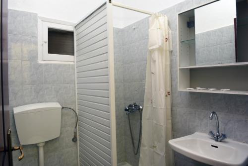 a bathroom with a shower and a sink at Hotel Dias Apartment in Makrygialos