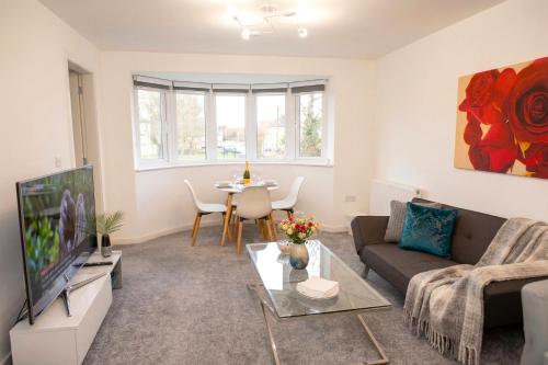 a living room with a couch and a tv at Panorama House, Modern 3-Bedroom Apartment 3, Oxford in Oxford