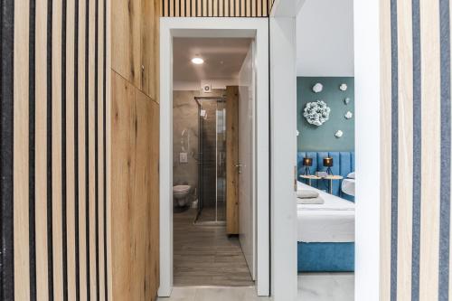 a bathroom with a toilet and a sink at The Butterfly Apartment | Seafront & Amazing Views by PikHost in Lezhë