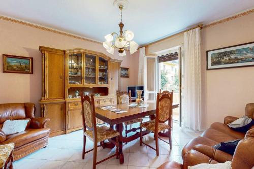 a dining room with a table and chairs and a couch at [Soleado] Il primo caffè con il sole da 3 lati in Acqui Terme