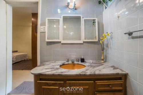 a bathroom with a sink and two mirrors at Studio in Condo w/ Pool in Downtown QUI0605 in Poços de Caldas