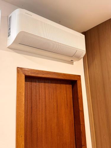 a air conditioner above the door of a room at STUDIO Flat B in Betim
