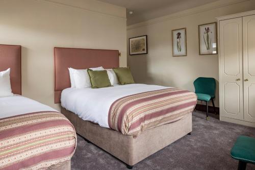 a hotel room with two beds and a chair at O'Donoghue's in Dublin