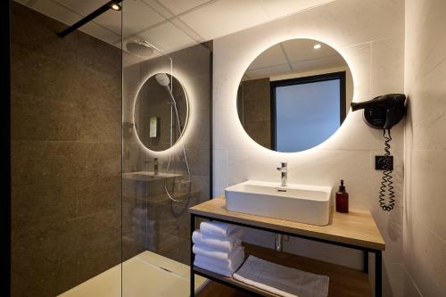 a bathroom with a sink and a mirror at Campanile Le Mans - Arnage in Arnage