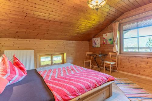 a bedroom with a bed in a wooden cabin at Wieshof in Kaltenbach
