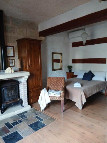 a bedroom with a bed and a fireplace at Gozo Duplex Studio overlooking historic Piazza in Victoria