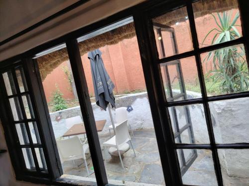 a view of a table and chairs through a window at Beverly Hills Lodge in Fourways