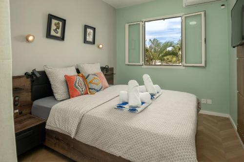 a bedroom with a bed with towels on it at Atlantique Créole - Crystal Beach, Saint-François in Saint-François