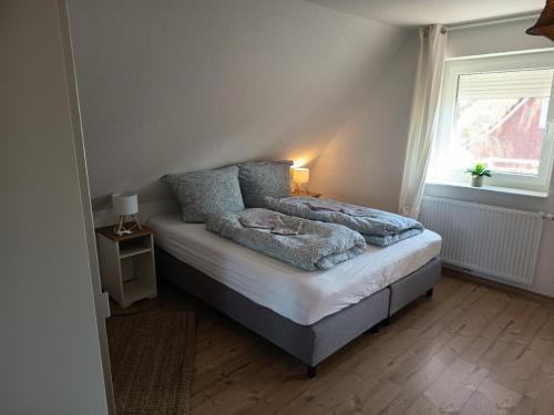 a bedroom with a bed and a window at Haus Lützowallee in Aurich