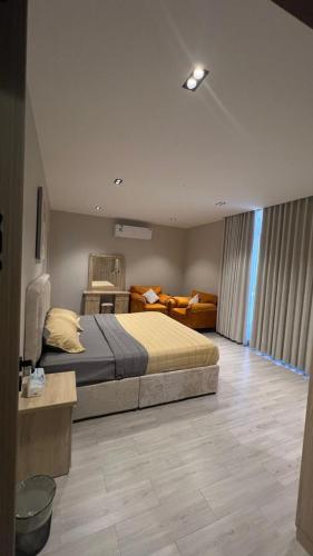 a bedroom with a bed and a living room at شالية موج 335 in Dhahran