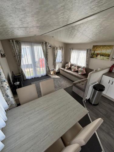 a living room with a table and chairs and a couch at Seaview Holiday Rentals in Whitstable