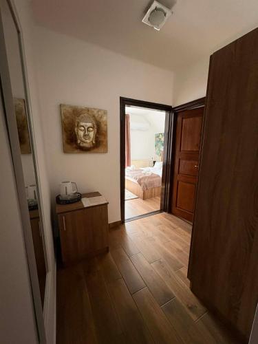 a hallway with a room with a bed and a mirror at Shubu Zen Vendégház in Szilvásvárad