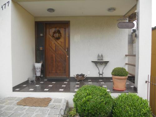 a front door of a house with plants at Hospedagem Three Little Birds in Curitiba