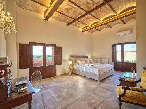 a bedroom with a bed and a couch and a table at Villa Eos in Chiusure