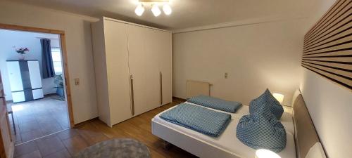 a small room with a bed and a hallway at Gästehaus Bergwald in Kurort Gohrisch