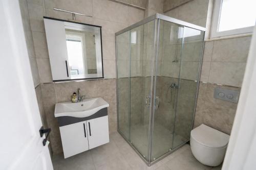 a bathroom with a shower and a sink and a toilet at Villa Horizon in Ortaca
