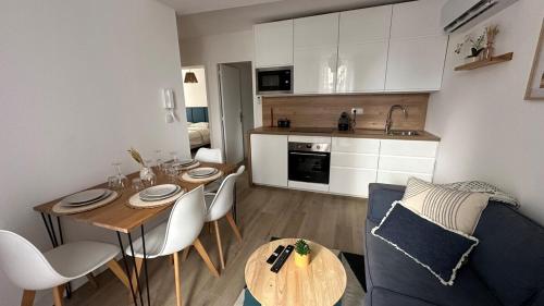 a kitchen and living room with a table and chairs at la capeline in Chablis
