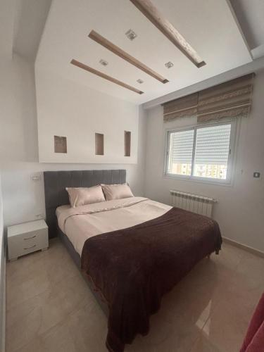a bedroom with a large bed and a window at Sea View 1 Bedroom Apartment with 100m Terrace in Sousse