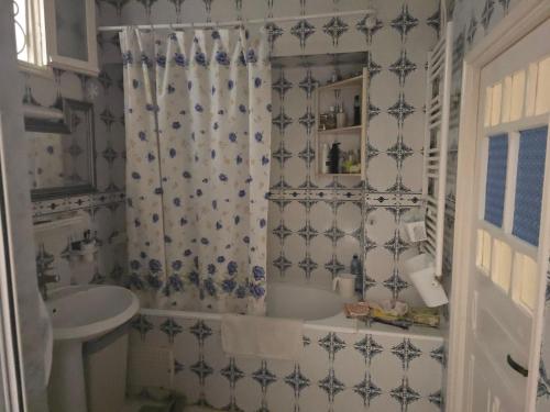 a bathroom with a tub and a sink at Dar lel khedija in Mahdia