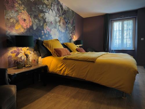 a bedroom with a large bed with a yellow blanket at Maison Lasmarenx chambres d'hôtes in Jurançon
