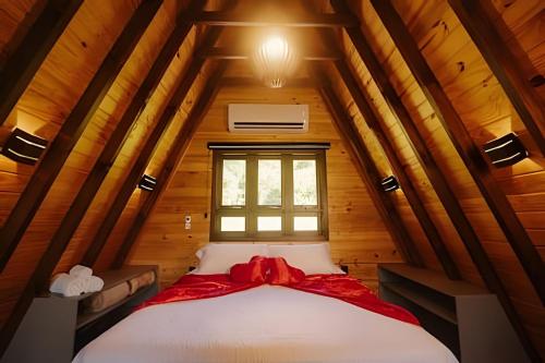 a bed in a room with a window at Alabama Cabin - Serra Gaúcha in Picada Cafe