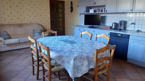 a kitchen with a table and chairs in a kitchen at Dépendance du Duesmois in Fontaines-en-Duesmois