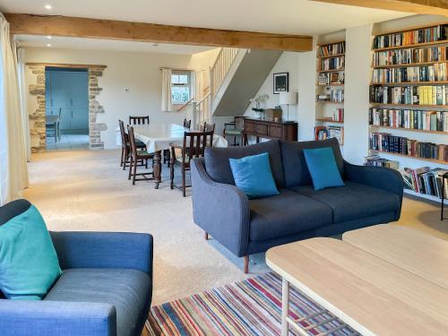 a living room with two couches and a dining room at The Cart House in Helmsley