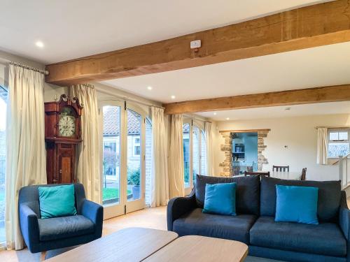 a living room with a couch and two chairs at The Cart House in Helmsley