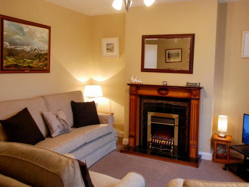 a living room with a couch and a fireplace at The Fells in Keswick