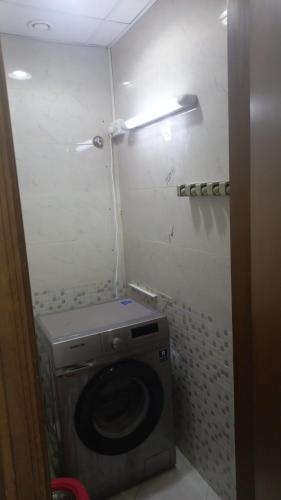 a bathroom with a washing machine in a room at Oasis TOWER 1105 in Ajman 