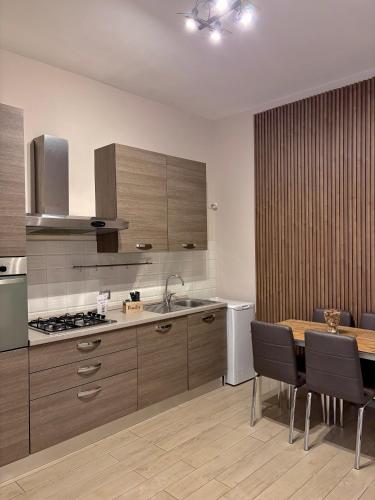 a kitchen with a table and a dining room at Il Palazzetto in Gaeta