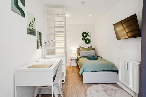 a bedroom with a bed and a desk and a ladder at Übernachtung an der A2 in Braunschweig