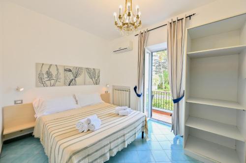 a bedroom with a bed with towels on it at Don Giorgio Studios in Ischia Town