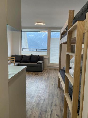 a living room with a couch and a bunk bed at Studio Pod Kaninom in Bovec