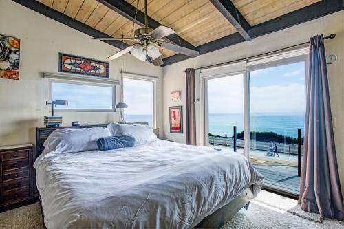a bedroom with a bed with a view of the ocean at Catch some waves! Panoramic ocean views!- Cardiff Surfer in Cardiff-by-the-Sea