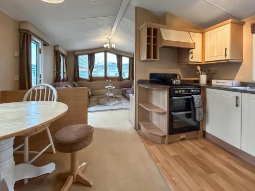 a kitchen with a table and a dining room at Uk51366 - The Harley Davidson in Brechin
