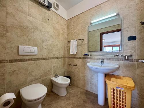 a bathroom with a sink and a toilet and a mirror at Lighthouse Rafailovići, Budva in Rafailovici