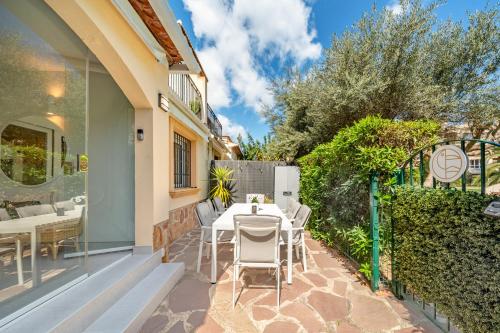 a patio with a table and chairs and a fence at Casa Tucan Javea, luxury close to Arenal Beach in Jávea