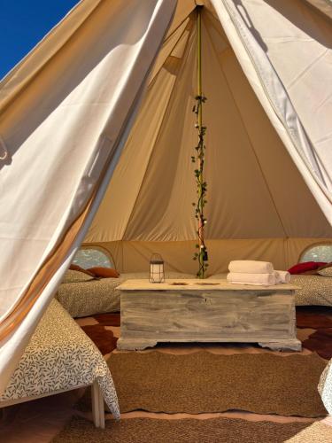 a tent with a table in the middle at Bubble Inn Eco Village in Montecopiolo