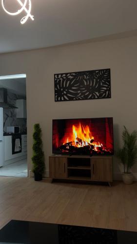 a fireplace in a living room with a fire in it at Luxury rooms in Ashton under Lyne