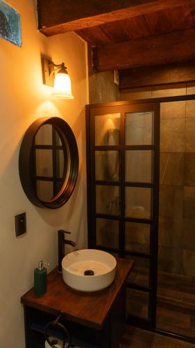 a bathroom with a sink and a mirror at Casa Dabne in San Cristóbal de Las Casas