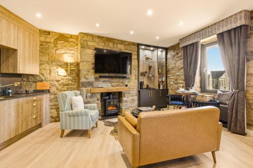 a living room with a couch and a tv at Just us Two - North East Escapes in Amble
