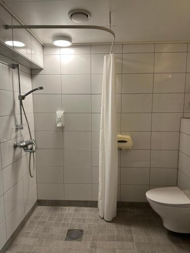 a bathroom with a shower and a toilet at Casual Housing Kemi in Kemi